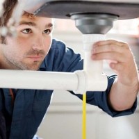 plumber fixing sink pipes