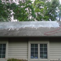 man on roof washing it