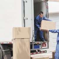 movers loading a truck and clients watching them