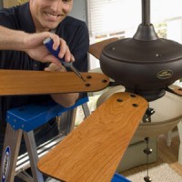 man installing a ceiling fan